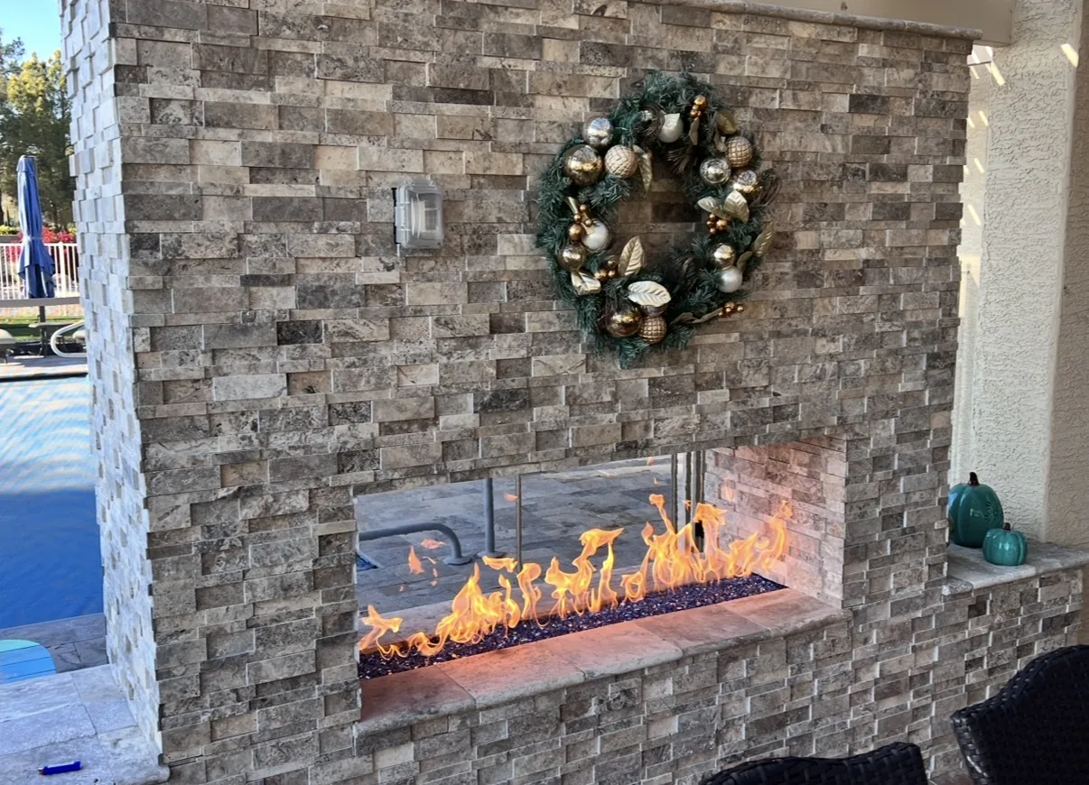 Custom outdoor stone fireplace by AZ Top Remodeling
